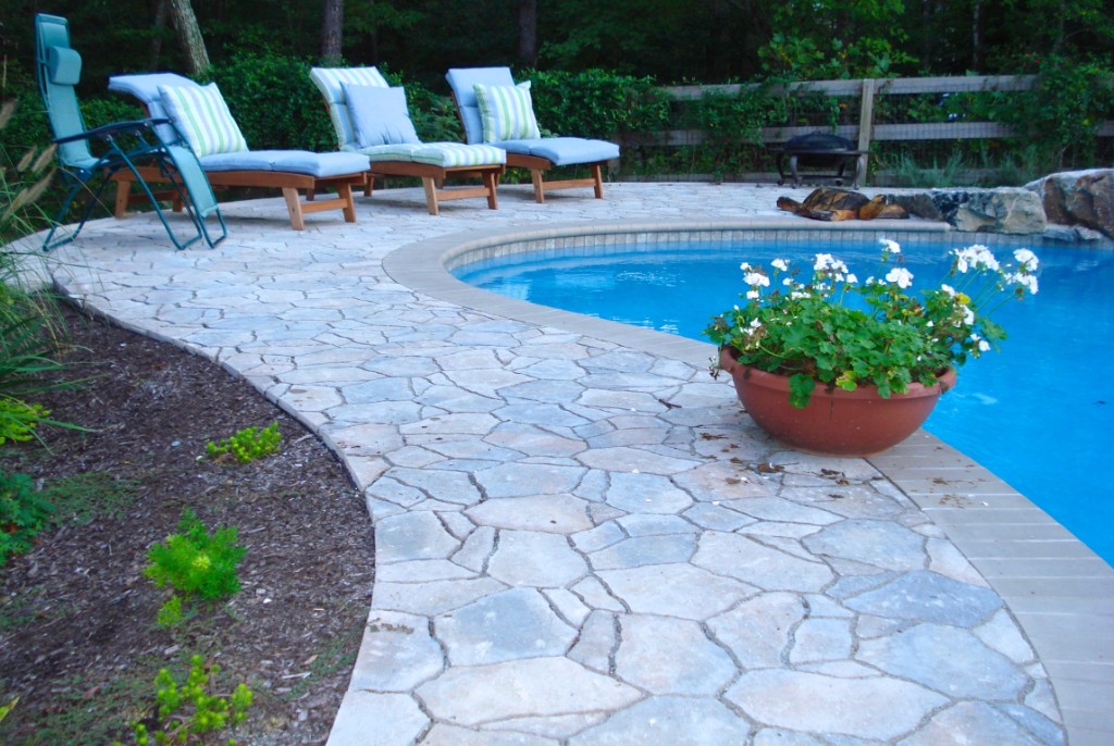 Custom swimming pool — flagstone patio and lounge chairs